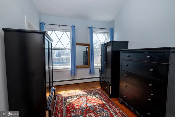 a living room with furniture a window and a flat screen tv