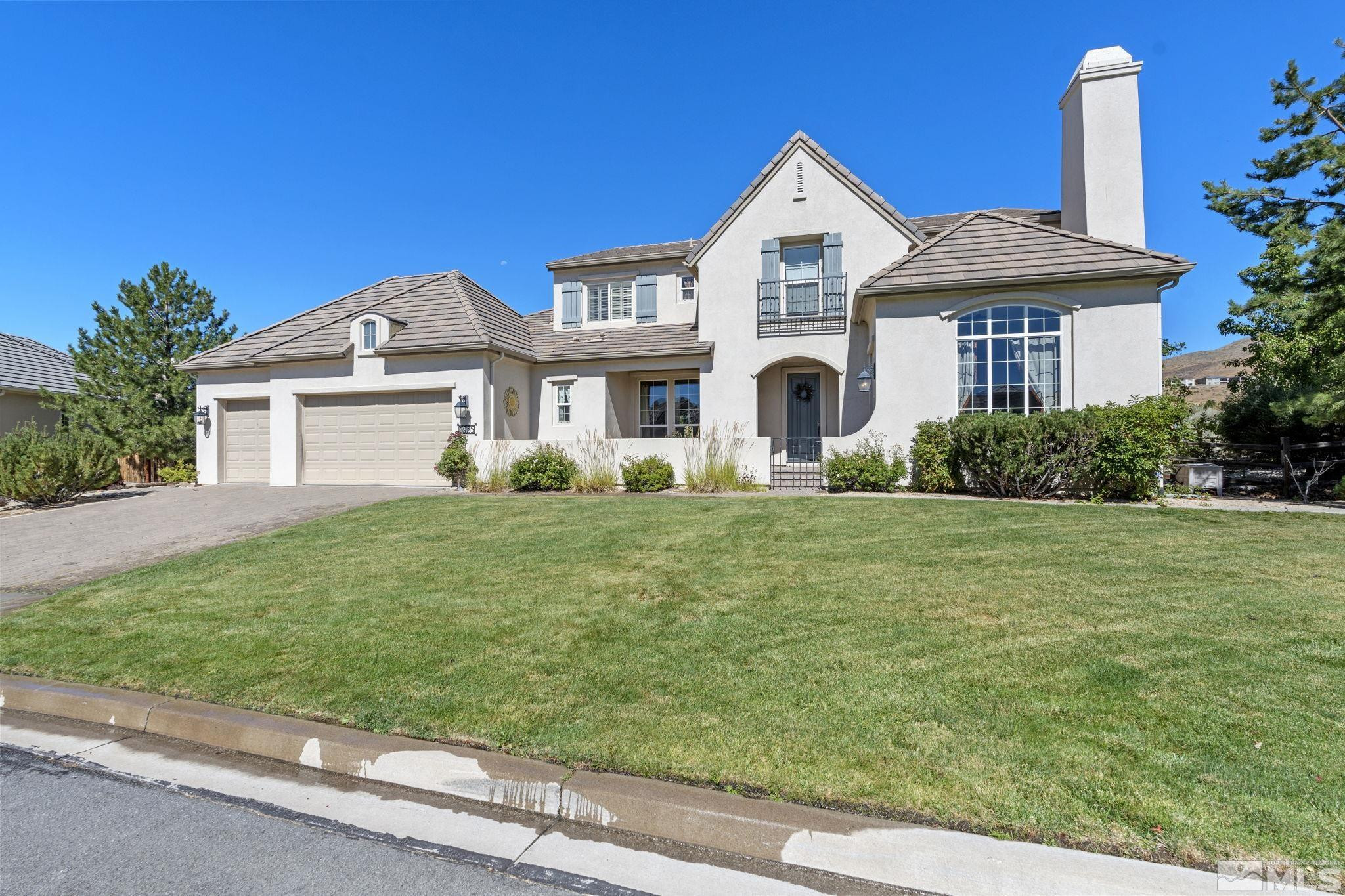 1955 Bechtol Ridge Circle Reno, NV 89523 - Photo 1 of 38 a front view of a house with a garden