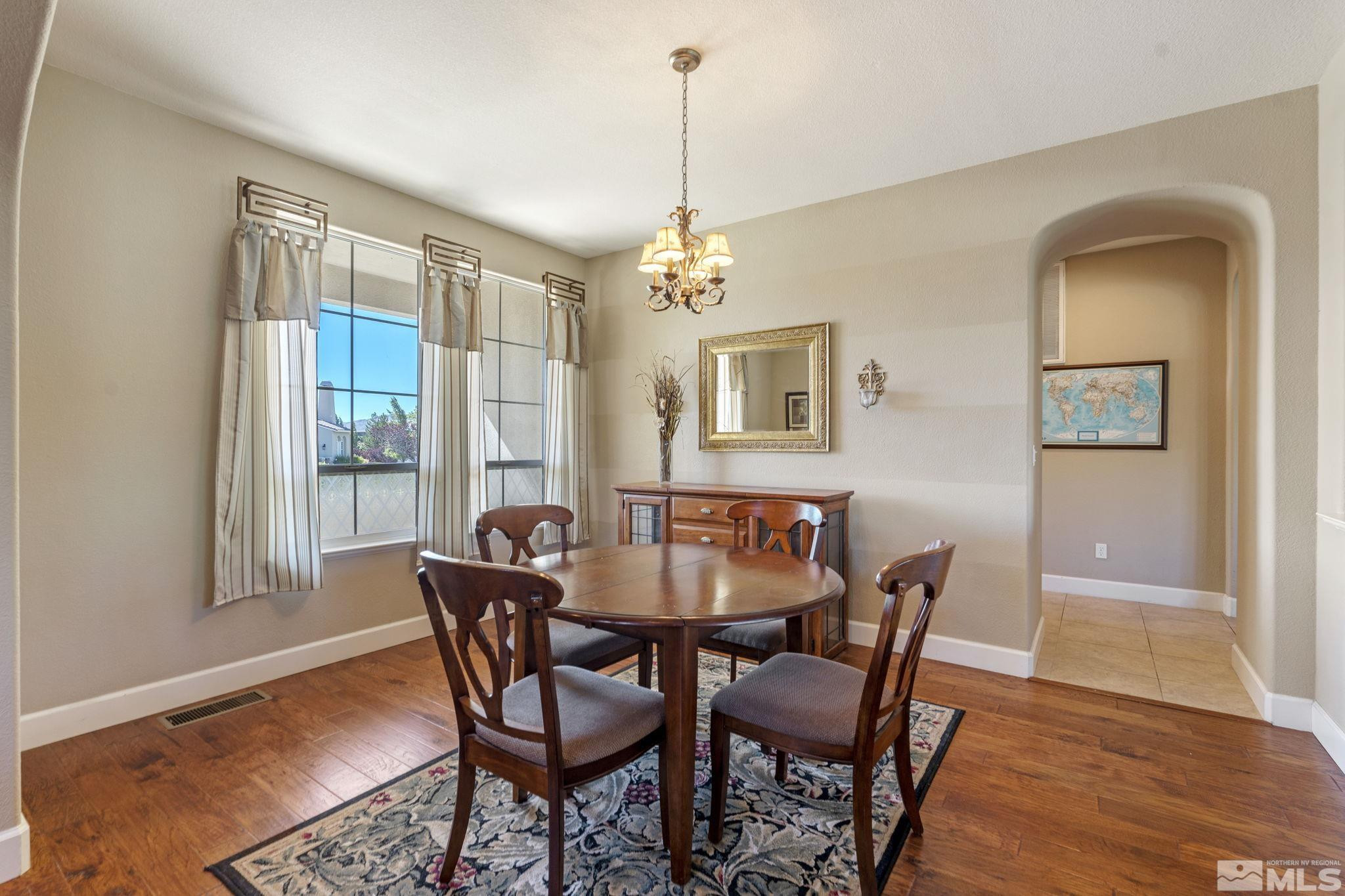 1955 Bechtol Ridge Circle Reno, NV 89523 - Photo 13 of 38 a dining room with furniture a chandelier and wooden floor