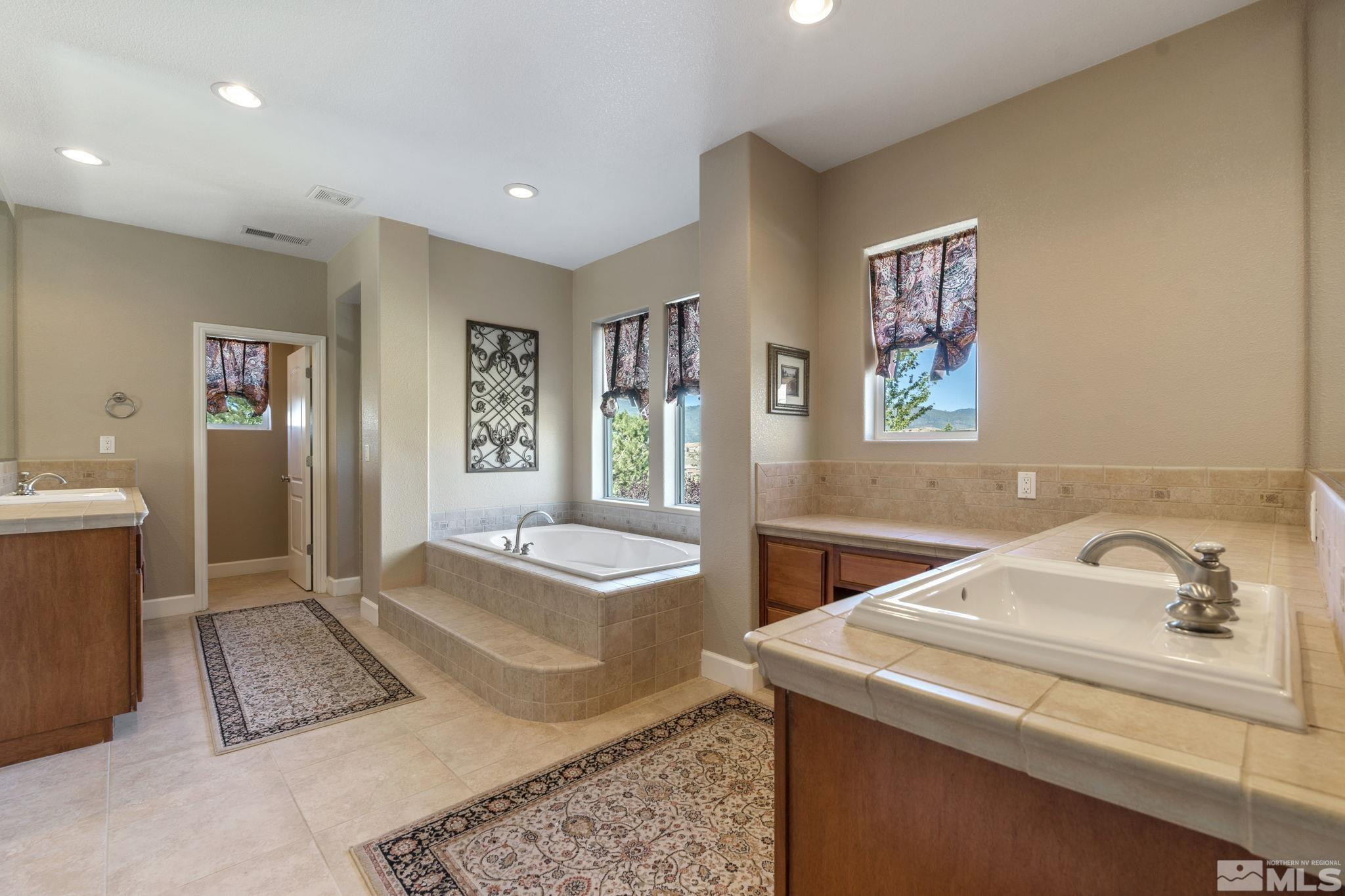 1955 Bechtol Ridge Circle Reno, NV 89523 - Photo 21 of 38 a bathroom with a sink a bathtub and a window