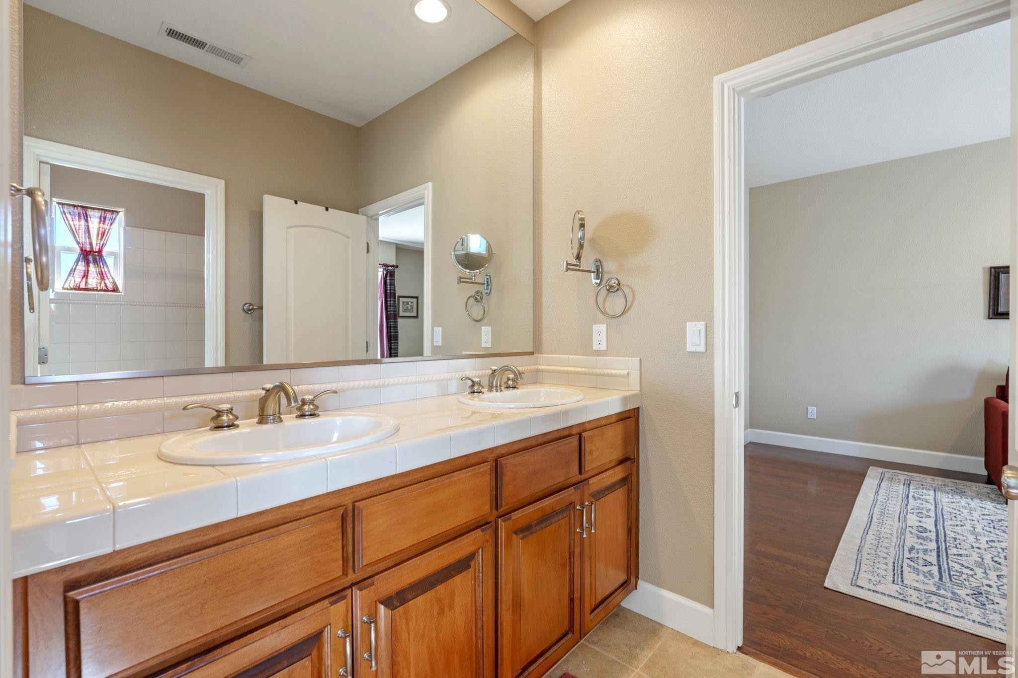1955 Bechtol Ridge Circle Reno, NV 89523 - Photo 26 of 38 a bathroom with a sink and a mirror