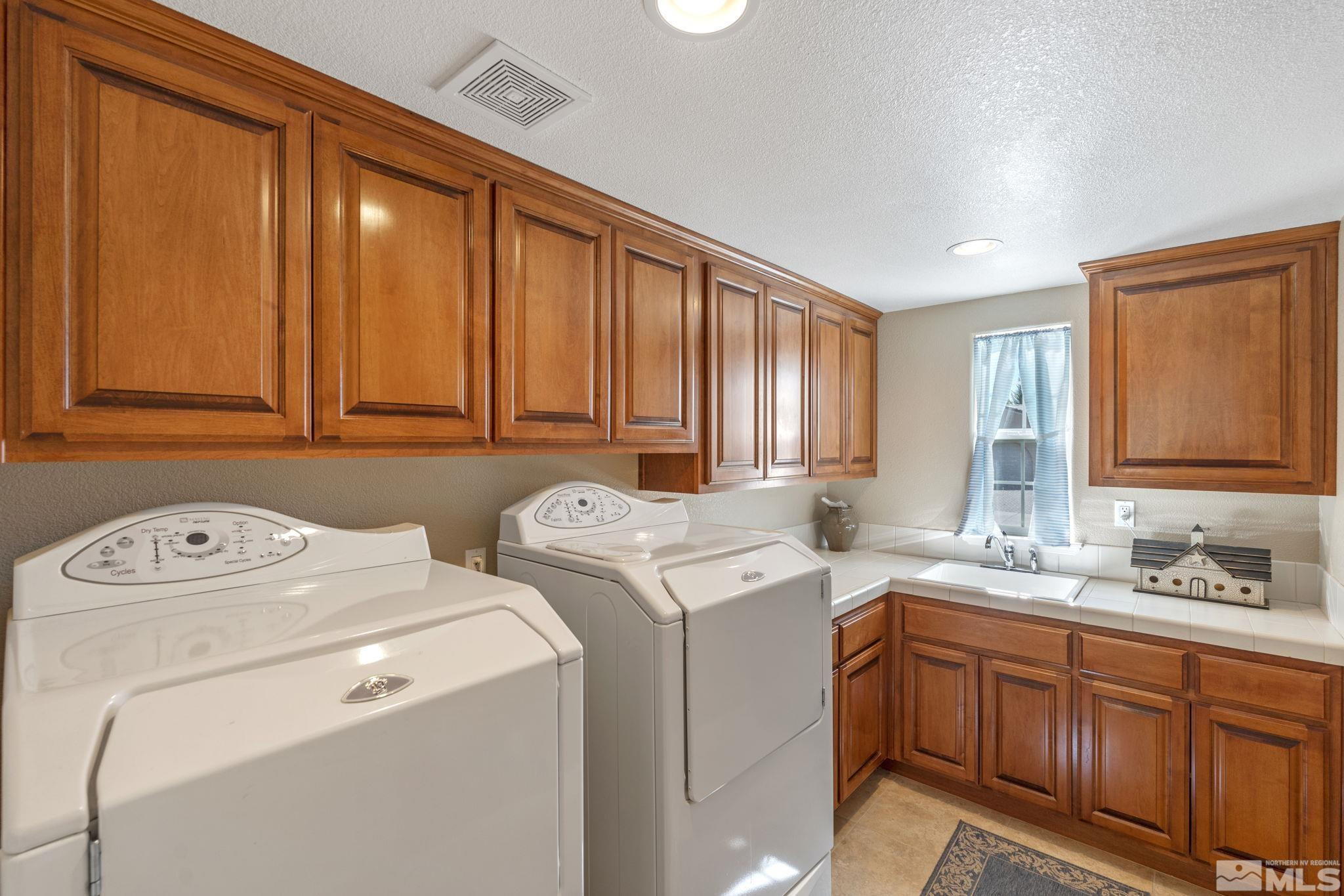 1955 Bechtol Ridge Circle Reno, NV 89523 - Photo 29 of 38 a utility room with dryer and washer