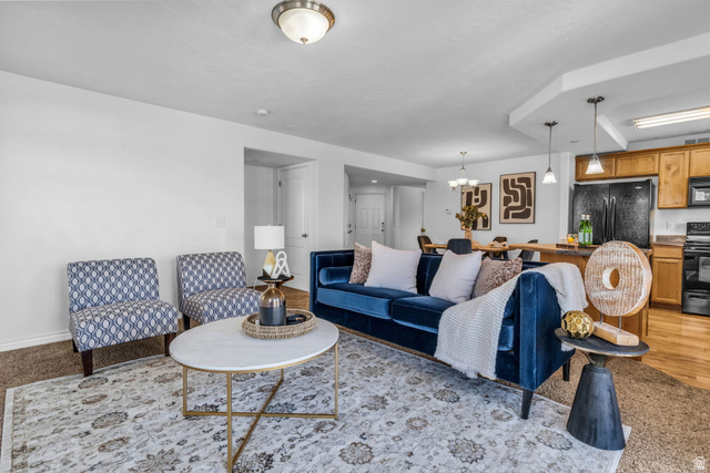 1136 West Spencer Road, Unit Y203 Pleasant Grove, UT 84062 - Photo 7 of 26 Living room with suspended lighting and light colored carpet