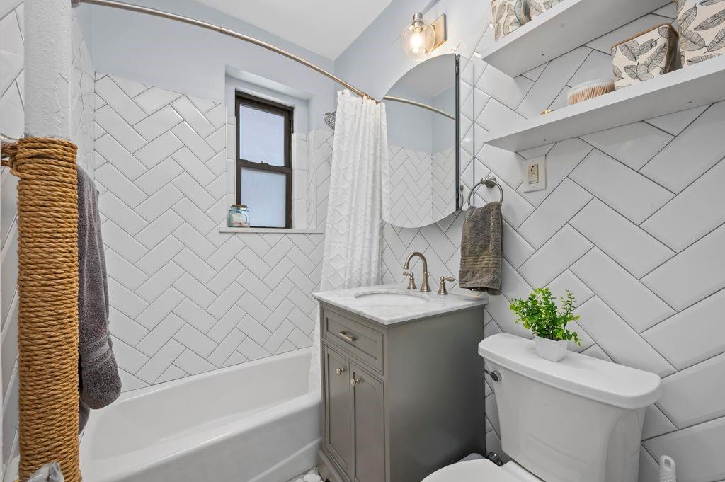 9701 Shore Road, Unit 1O Brooklyn, NY 11209 - Photo 11 of 23 a bathroom with a sink toilet and shower