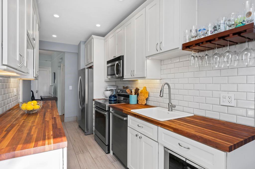 9701 Shore Road, Unit 1O Brooklyn, NY 11209 - Photo 2 of 23 a kitchen with stainless steel appliances a sink dishwasher a refrigerator a stove top oven a sink and dishwasher
