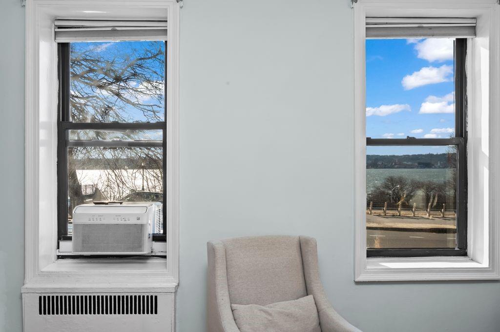 9701 Shore Road, Unit 1O Brooklyn, NY 11209 - Photo 6 of 23 a living room with a couch and a window