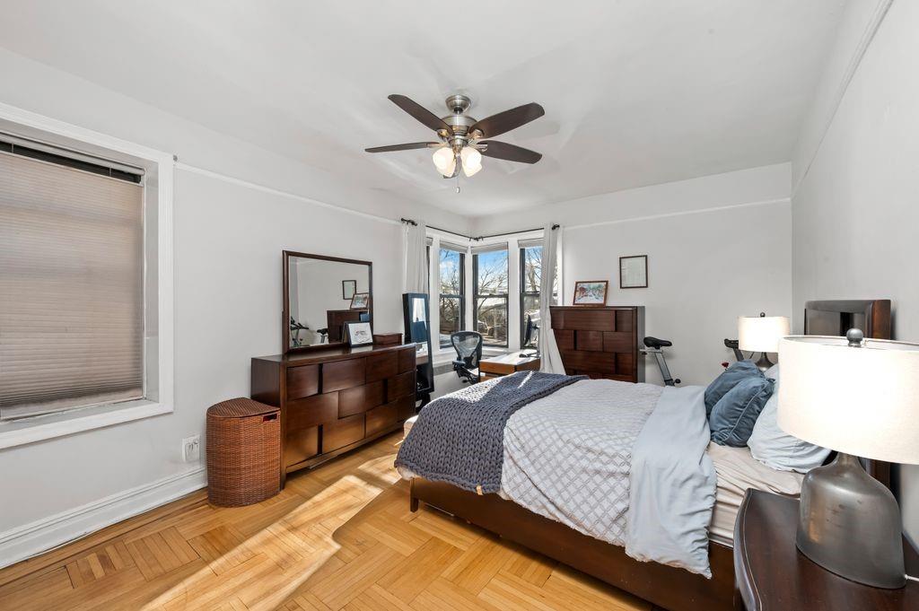 9701 Shore Road, Unit 1O Brooklyn, NY 11209 - Photo 10 of 23 a bedroom with a bed and a chandelier
