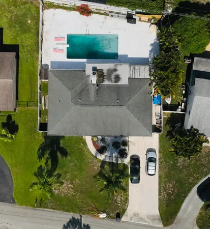 an aerial view of a house with a yard