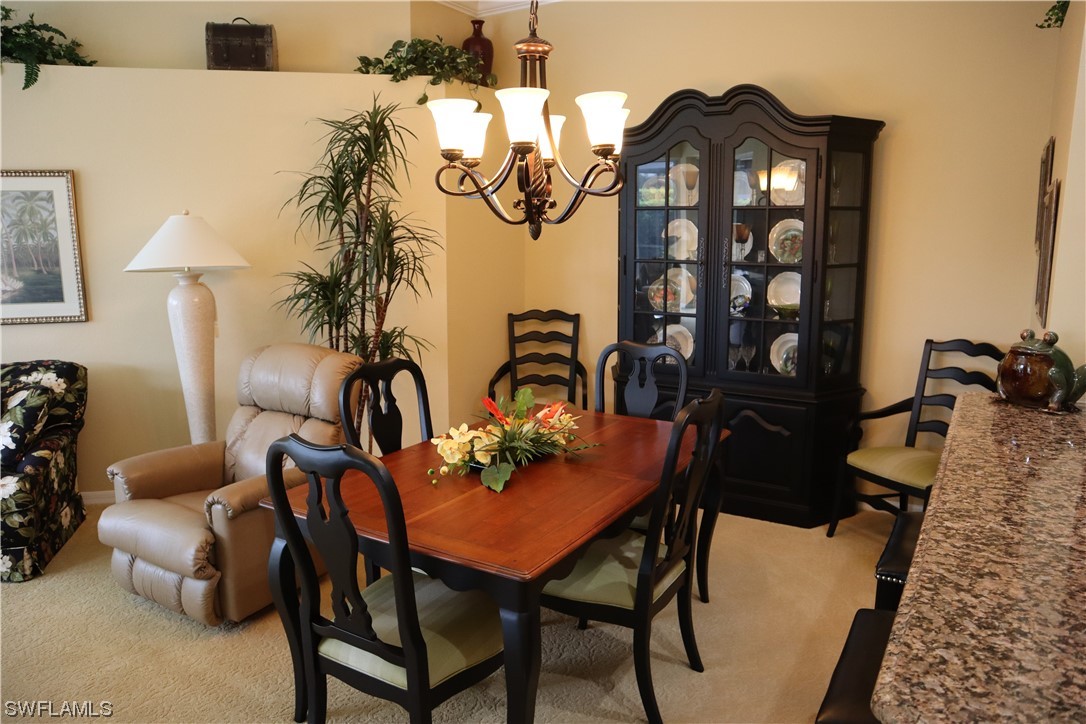 10325 Cape Roman Road, Unit 101 Estero, FL 34135 - Photo 11 of 34 a view of a dining room with furniture and wooden floor