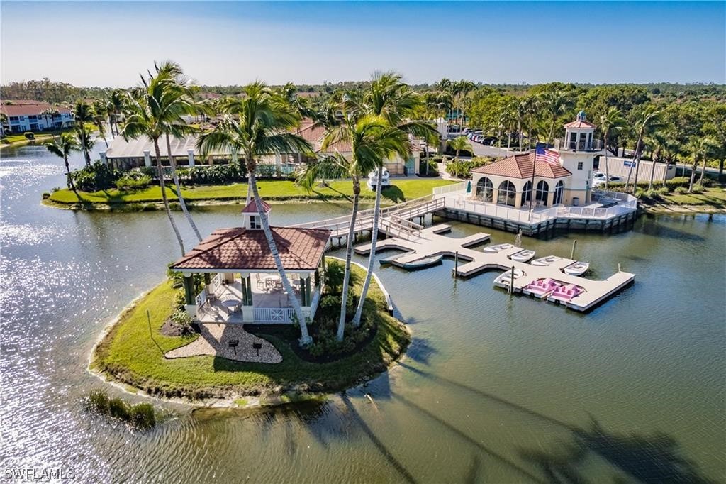 10325 Cape Roman Road, Unit 101 Estero, FL 34135 - Photo 31 of 34 a view of a lake with a table and chairs