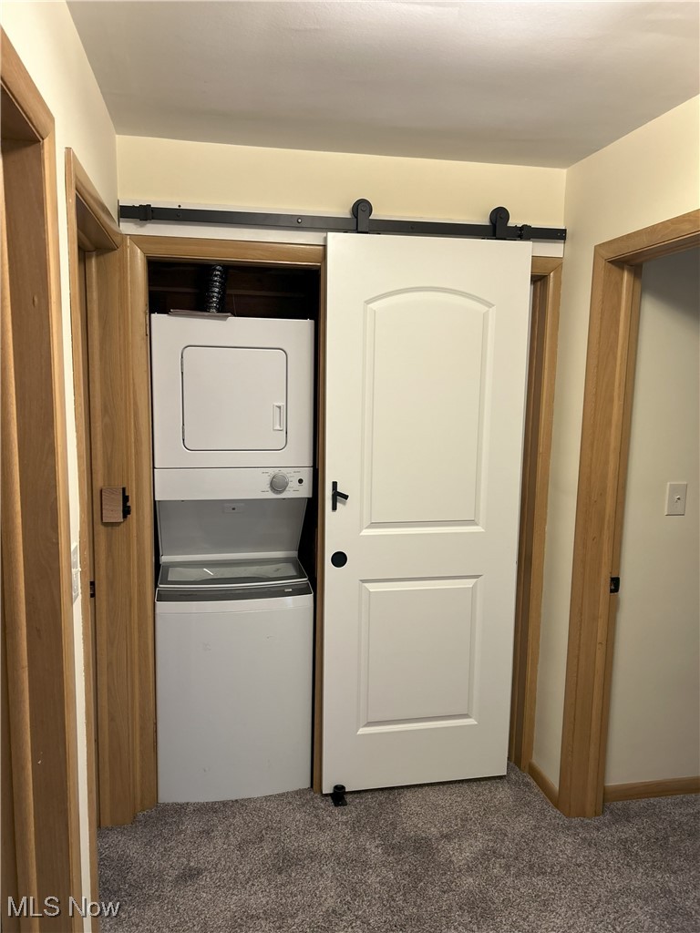 3215 Stanley Road Akron, OH 44333 - Photo 20 of 30 Laundry area featuring stacked washer / dryer and carpet