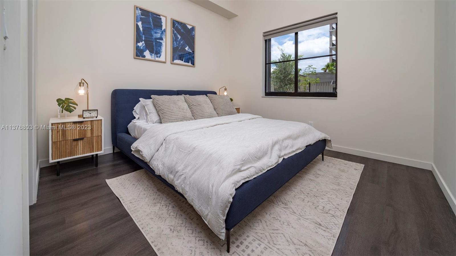6970 Southwest 40th Street, Unit 442 Miami, FL 33155 - Photo 13 of 23 a large bed sitting in a bedroom next to a window