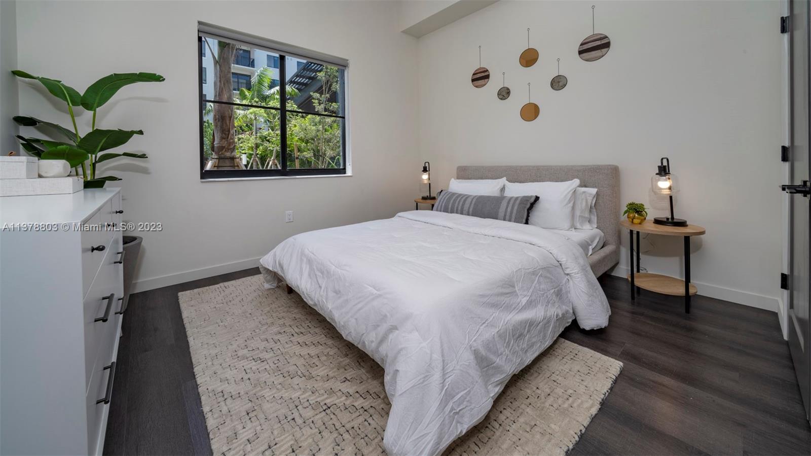 6970 Southwest 40th Street, Unit 442 Miami, FL 33155 - Photo 14 of 23 a bed sitting in a bedroom next to a window