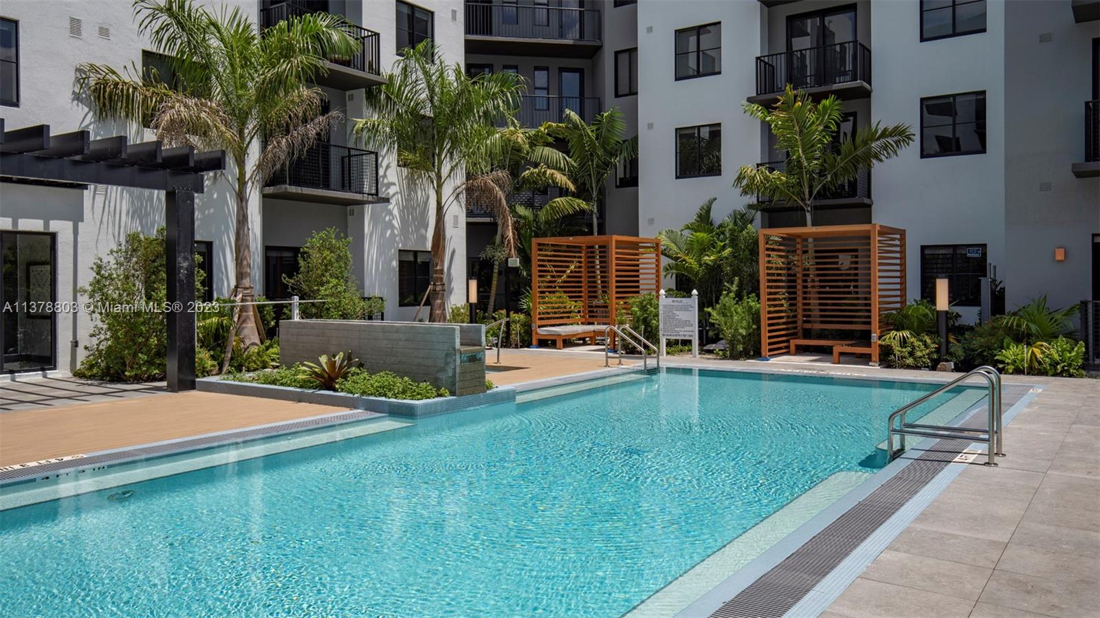 6970 Southwest 40th Street, Unit 442 Miami, FL 33155 - Photo 23 of 23 front view of house with a yard and potted plants