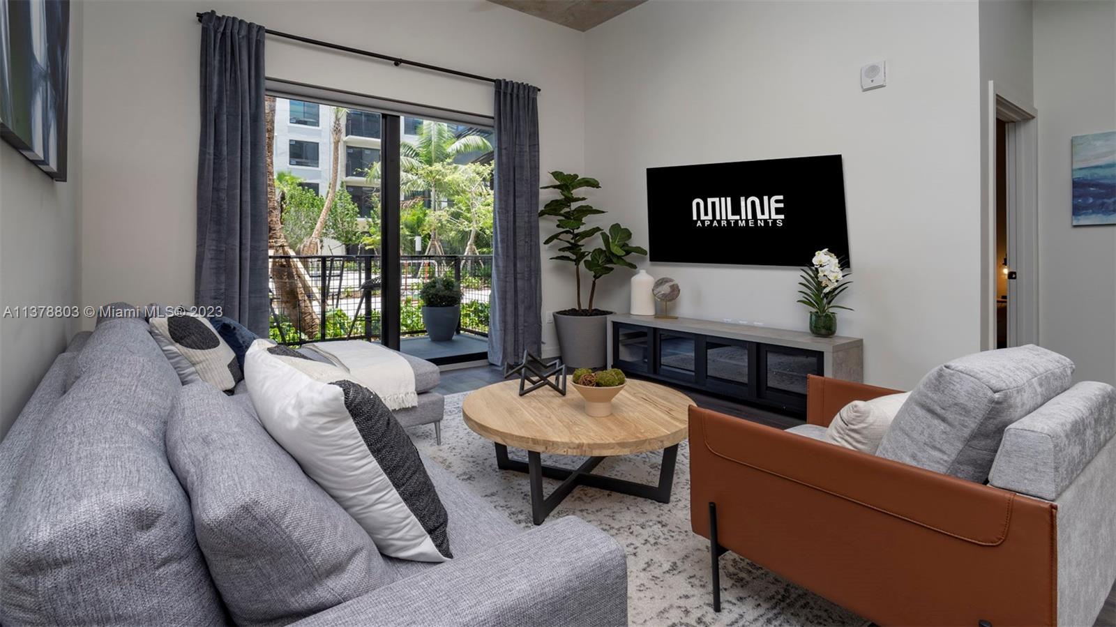 6970 Southwest 40th Street, Unit 442 Miami, FL 33155 - Photo 7 of 23 a living room with furniture and a large window