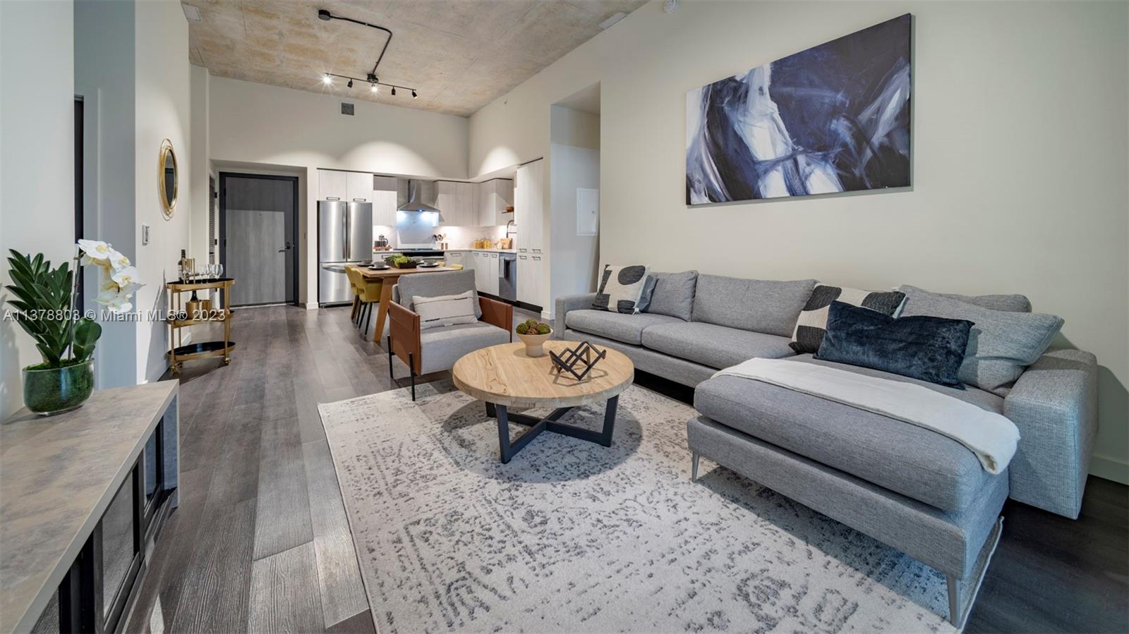 6970 Southwest 40th Street, Unit 442 Miami, FL 33155 - Photo 8 of 23 a living room with furniture a chandelier and a rug