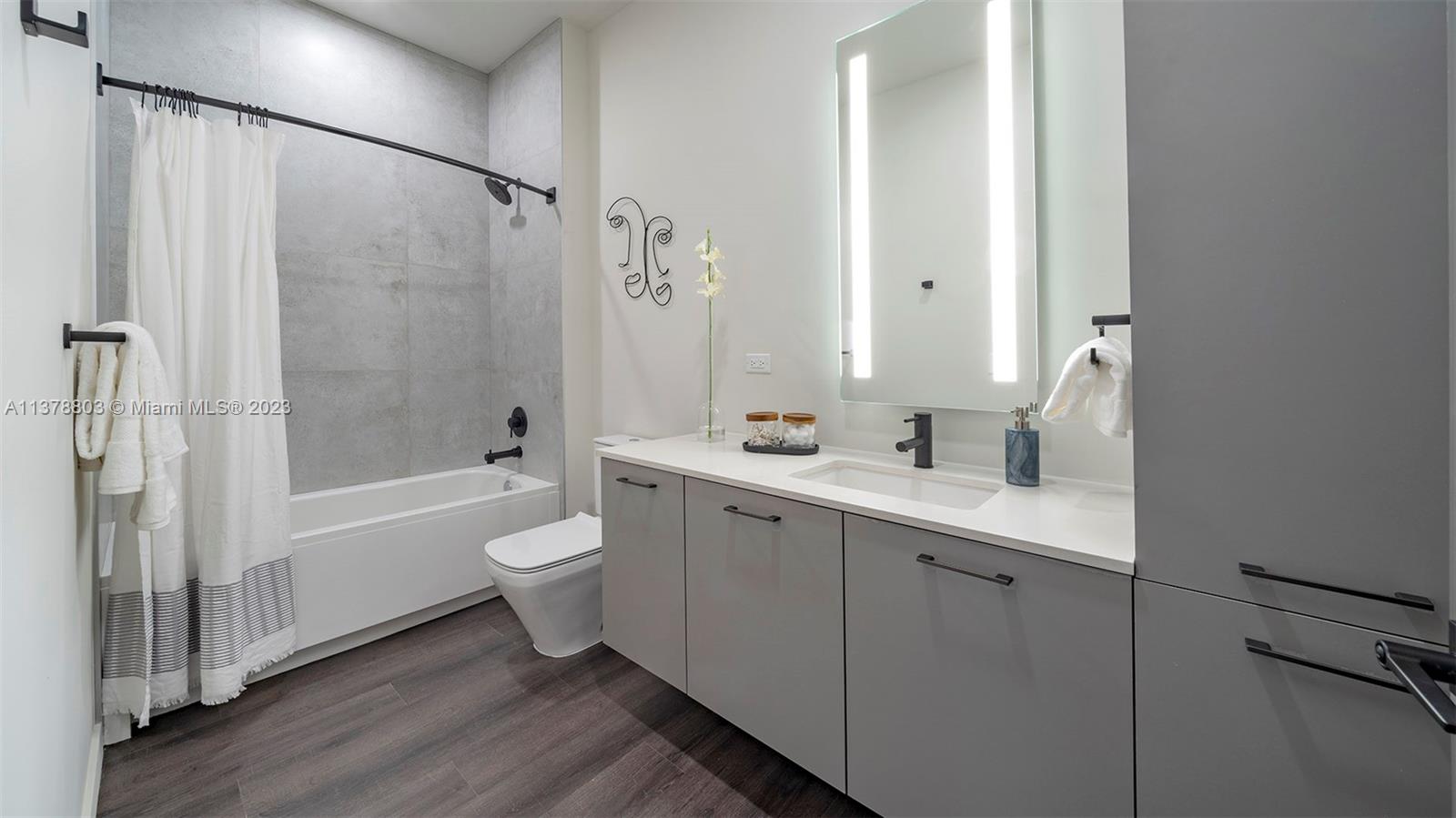 6970 Southwest 40th Street, Unit 442 Miami, FL 33155 - Photo 10 of 23 a bathroom with a double vanity sink toilet and shower