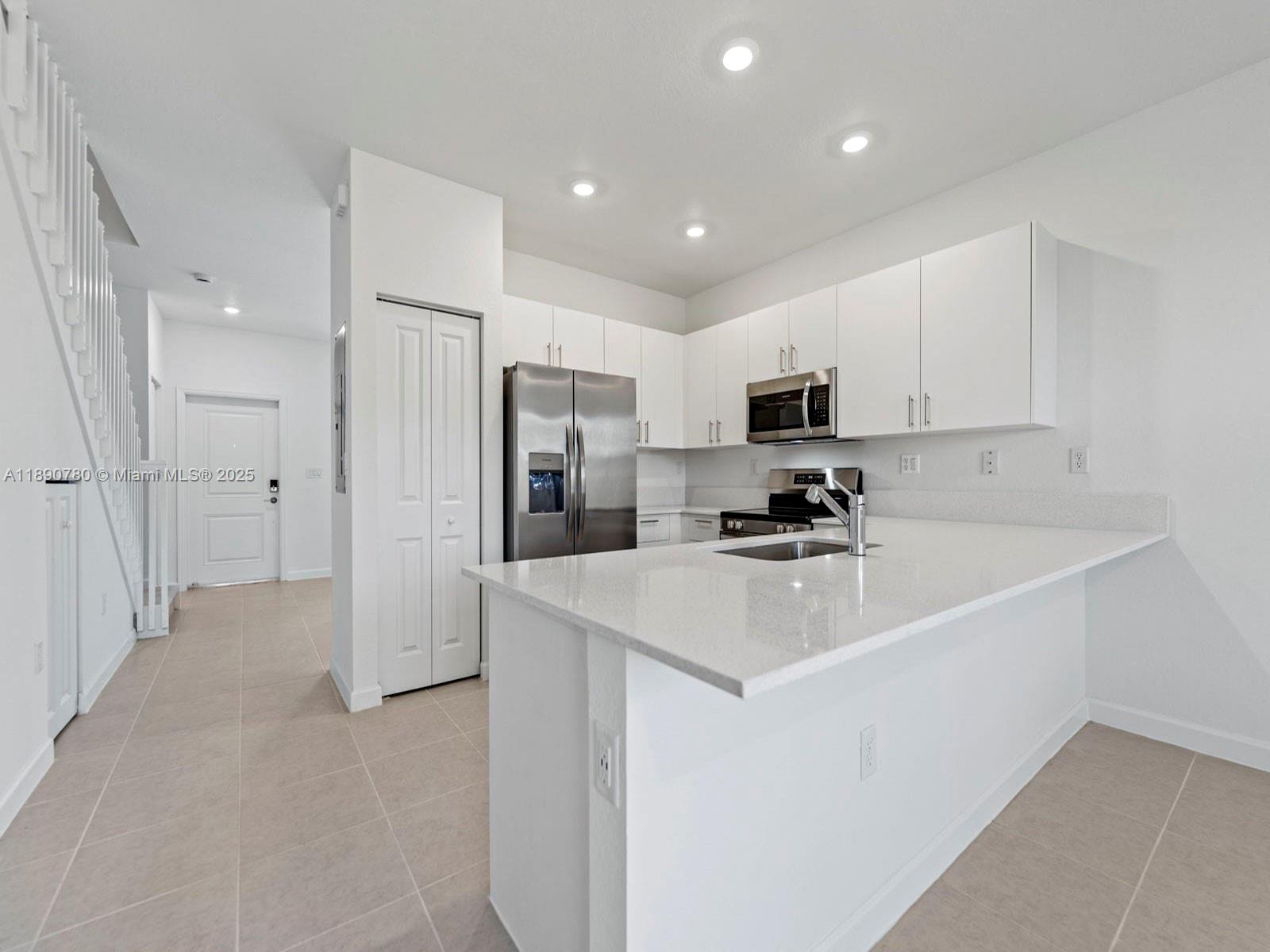 1529 Southeast 27th Street Homestead, FL 33035 - Photo 4 of 9 a kitchen with refrigerator cabinets and a sink