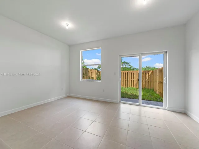 a view of an empty room with glass door