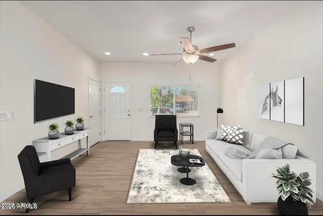 a living room with furniture a rug and a flat screen tv