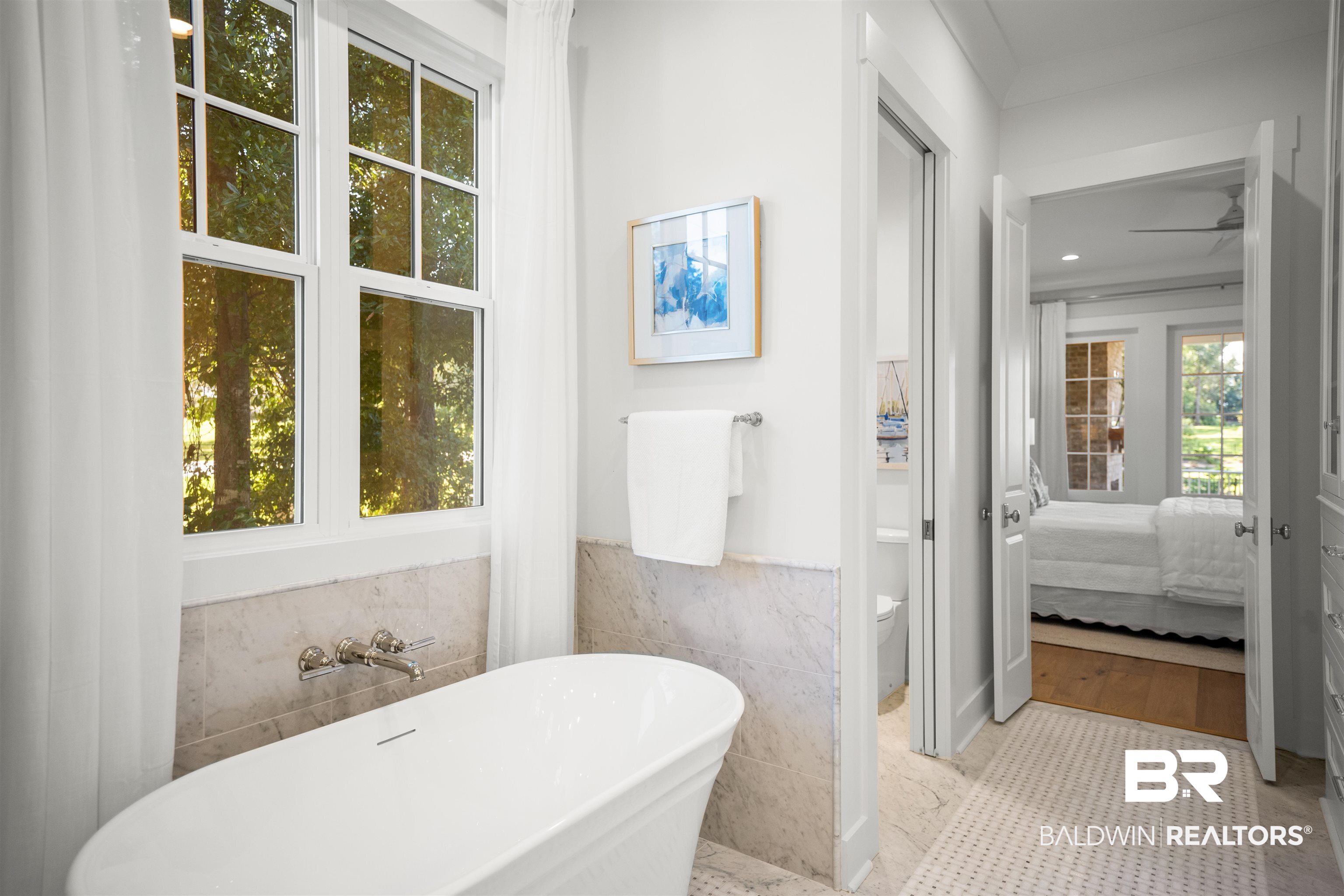 156 Hyacinth Street Fairhope, AL 36532 - Photo 42 of 61 Full bath featuring tile walls, a soaking tub, ensuite bathroom, a wainscoted wall, and tile patterned flooring