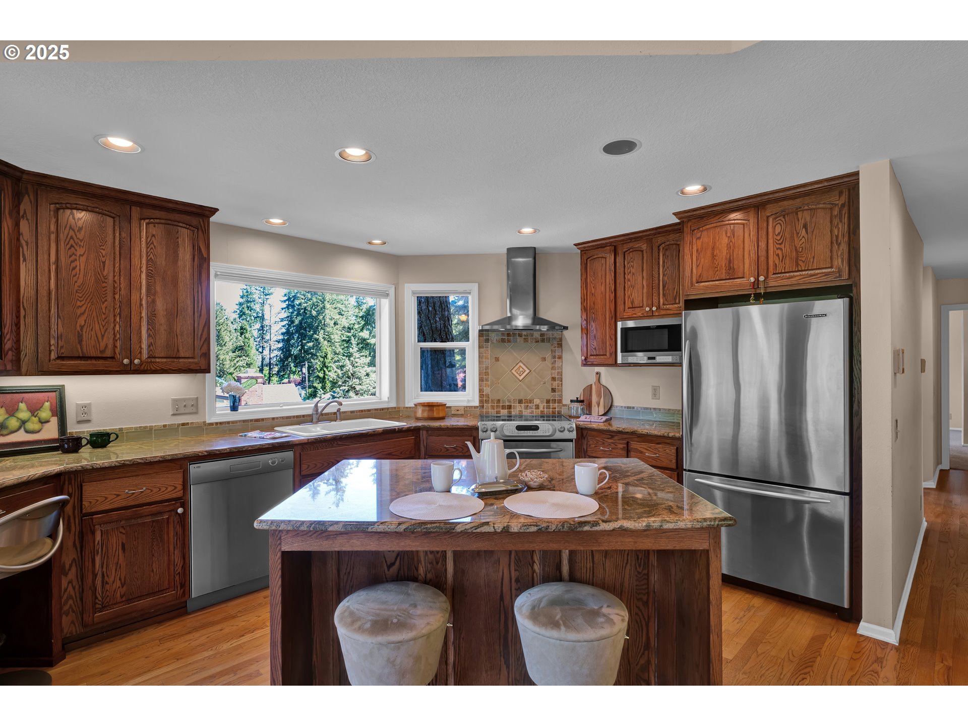 3348 Storey Boulevard Eugene, OR 97405 - Photo 16 of 47 a kitchen with kitchen island granite countertop a sink stove and refrigerator