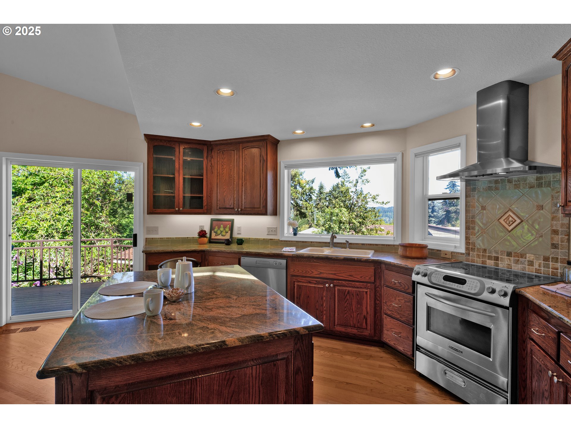 3348 Storey Boulevard Eugene, OR 97405 - Photo 18 of 47 a kitchen with kitchen island granite countertop a stove and a sink