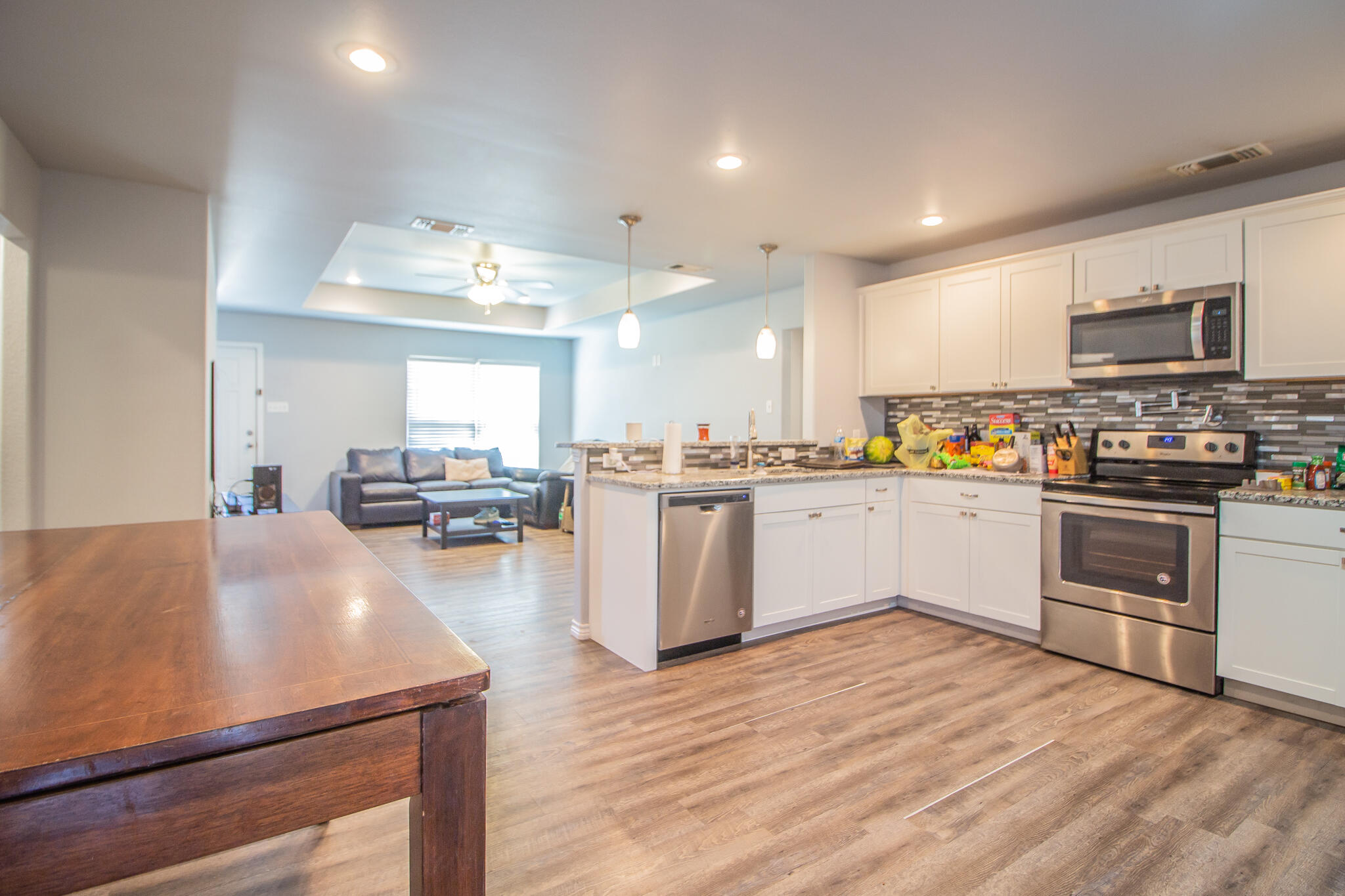 8808 14th Street Lubbock, TX 79416 - Photo 6 of 19 a kitchen with a sink cabinets and wooden floor