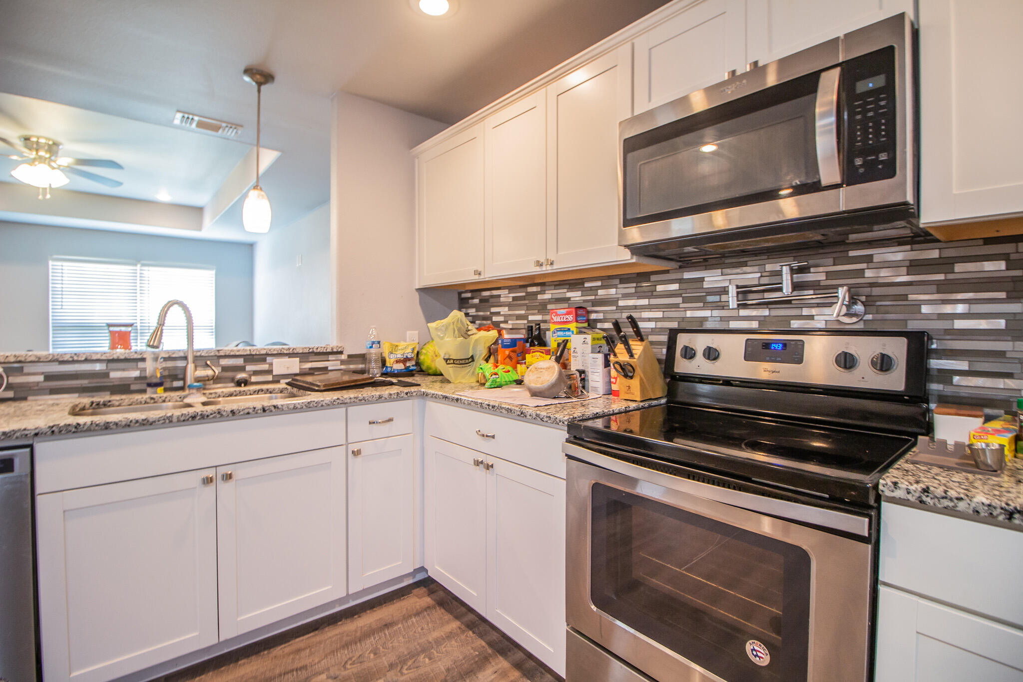 8808 14th Street Lubbock, TX 79416 - Photo 8 of 19 a kitchen with stainless steel appliances a stove microwave and cabinets