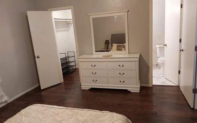 a room with a mirror and a wooden floor