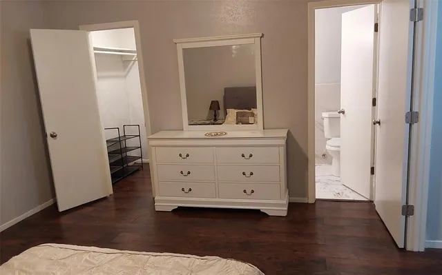 a room with a dresser and a mirror