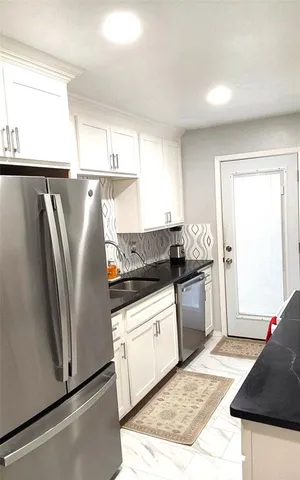 a kitchen with a refrigerator sink and stove