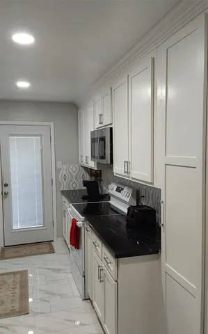 a kitchen with a sink and a refrigerator