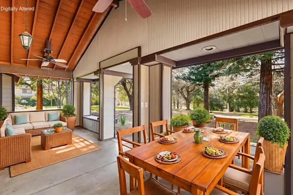 a view of a dining room with furniture large windows and wooden floor