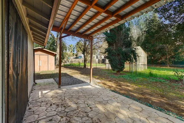 a view of a house with yard and tree s
