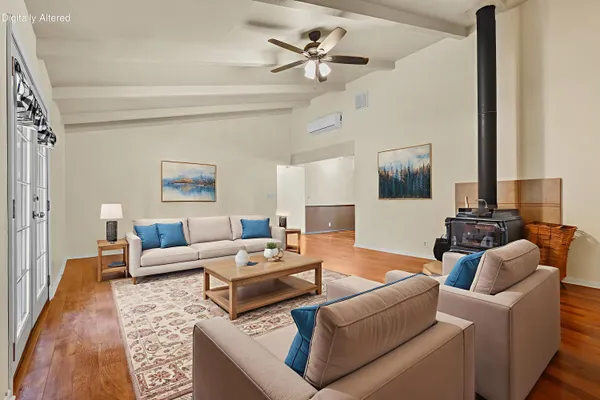 a living room with furniture ceiling fan and a rug