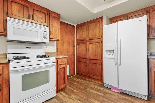 a kitchen with stainless steel appliances granite countertop a refrigerator sink and stove