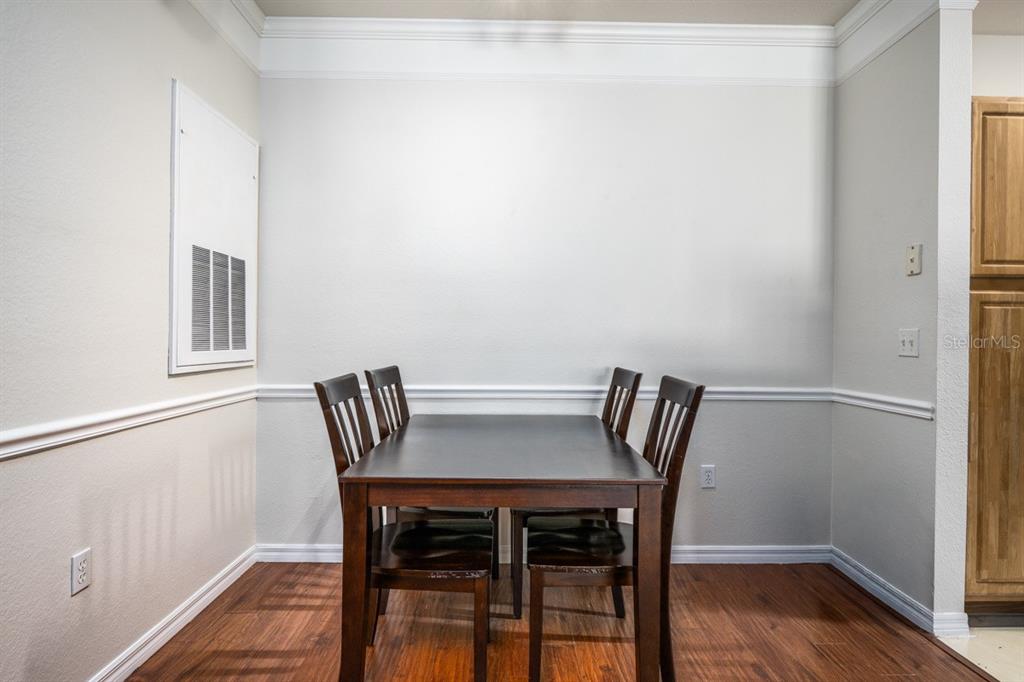 3468 Soho Street, Unit 303 Orlando, FL 32835 - Photo 11 of 21 a view of a dining room with furniture and wooden floor