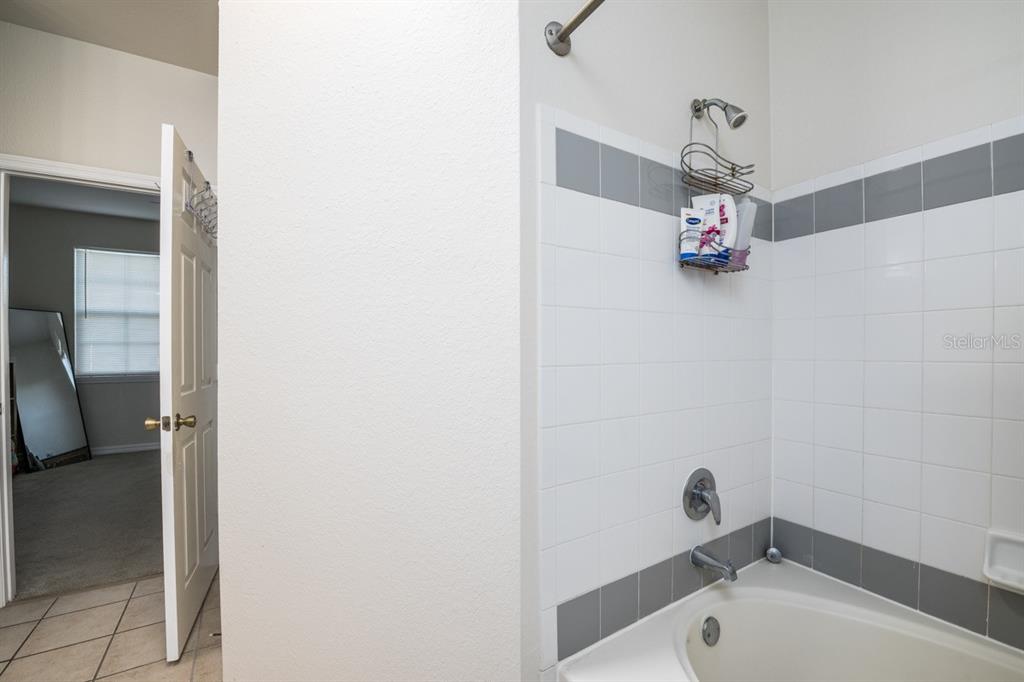 3468 Soho Street, Unit 303 Orlando, FL 32835 - Photo 12 of 21 a bathroom with a tub and shower