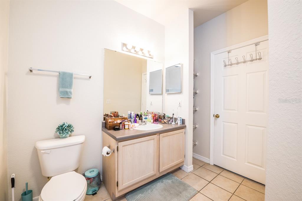 3468 Soho Street, Unit 303 Orlando, FL 32835 - Photo 13 of 21 a bathroom with a sink mirror vanity and toilet