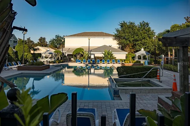 a front view of house with garden and trees