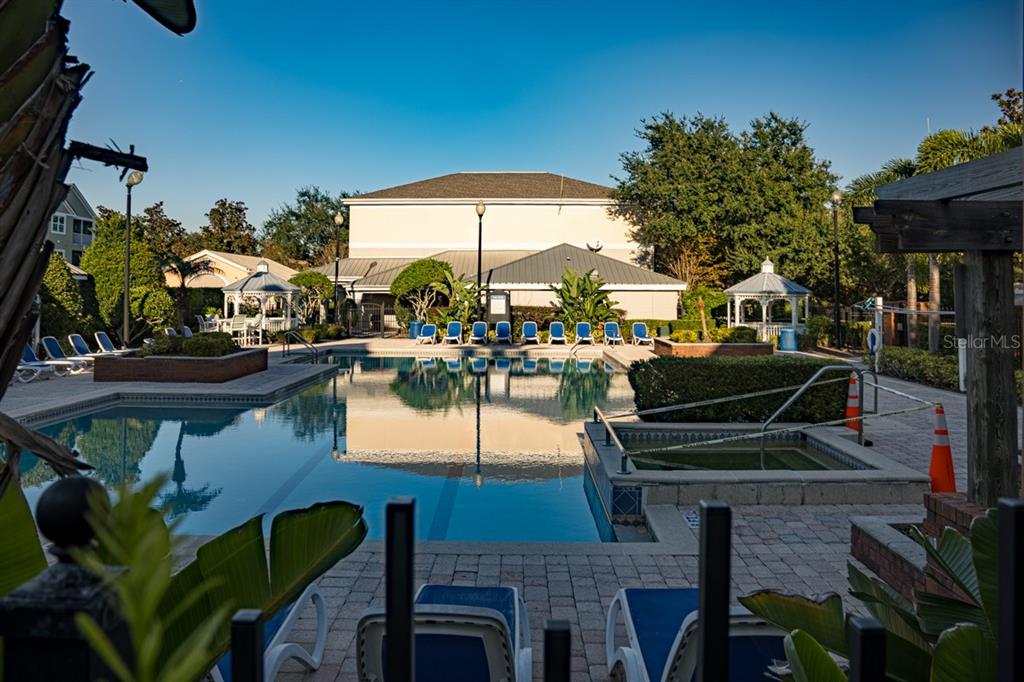 3468 Soho Street, Unit 303 Orlando, FL 32835 - Photo 18 of 21 a swimming pool with outdoor seating and yard