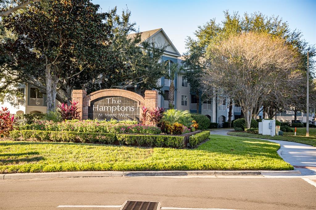 3468 Soho Street, Unit 303 Orlando, FL 32835 - Photo 19 of 21 a front view of house with garden and trees