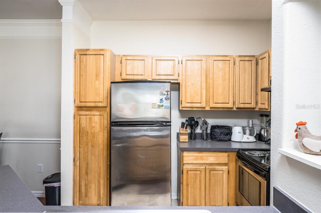3468 Soho Street, Unit 303 Orlando, FL 32835 - Photo 3 of 21 a kitchen with stainless steel appliances a refrigerator and a sink