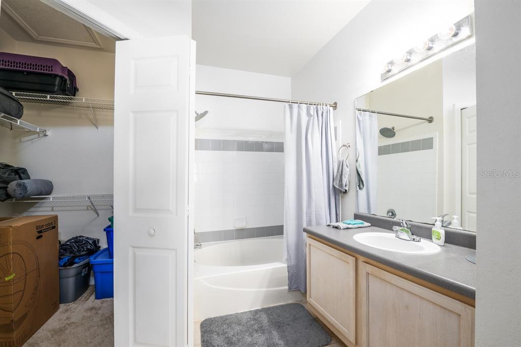 3468 Soho Street, Unit 303 Orlando, FL 32835 - Photo 6 of 21 a bathroom with a double vanity sink and a mirror