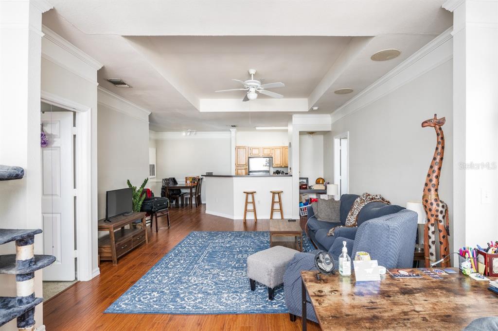 3468 Soho Street, Unit 303 Orlando, FL 32835 - Photo 7 of 21 a living room with furniture and wooden floor