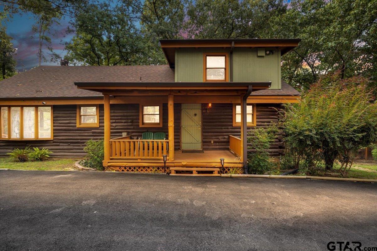 a view of house with outdoor space and porch