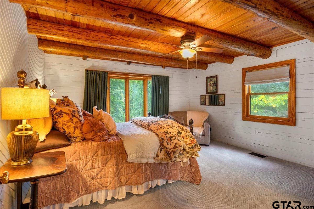 220 Dale Drive Avinger, TX 75630 - Photo 11 of 32 a bed sitting in a bedroom next to a window