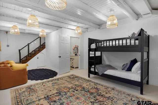 a bedroom with furniture and a book shelf