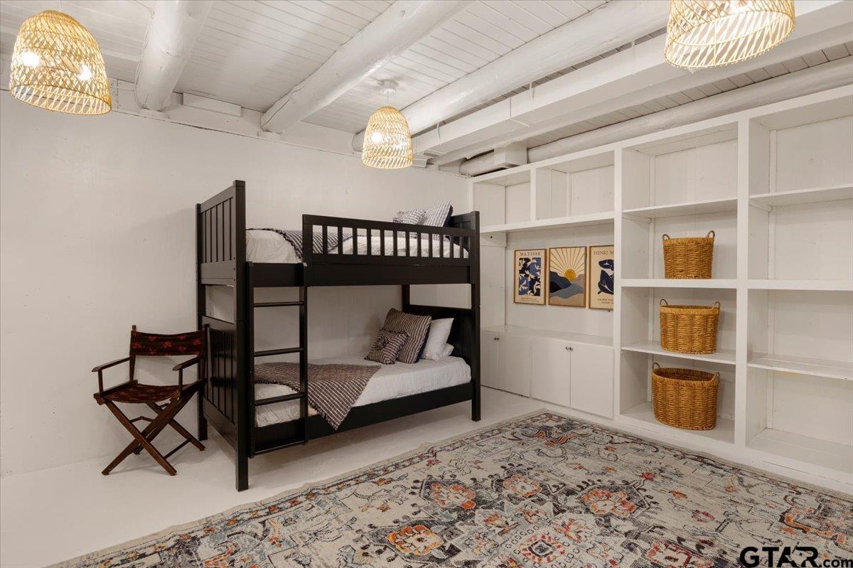 220 Dale Drive Avinger, TX 75630 - Photo 18 of 32 a bedroom with furniture and a book shelf